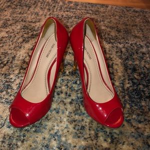 Red patent leather peep toe pumps